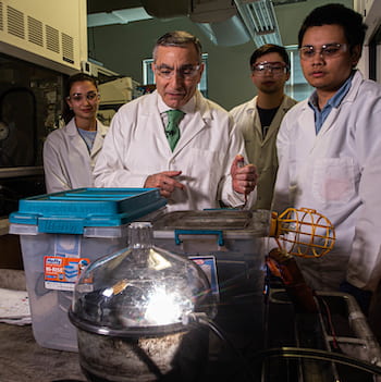 In a flash, carbon black turns into graphene through a technique developed by Rice University scientists. The scalable process promises to quickly turn carbon from any source into bulk graphene. From left: undergraduate intern Christina Crassas, chemist James Tour and graduate students Paul Advincula and Duy Luong. Photo by Jeff Fitlow